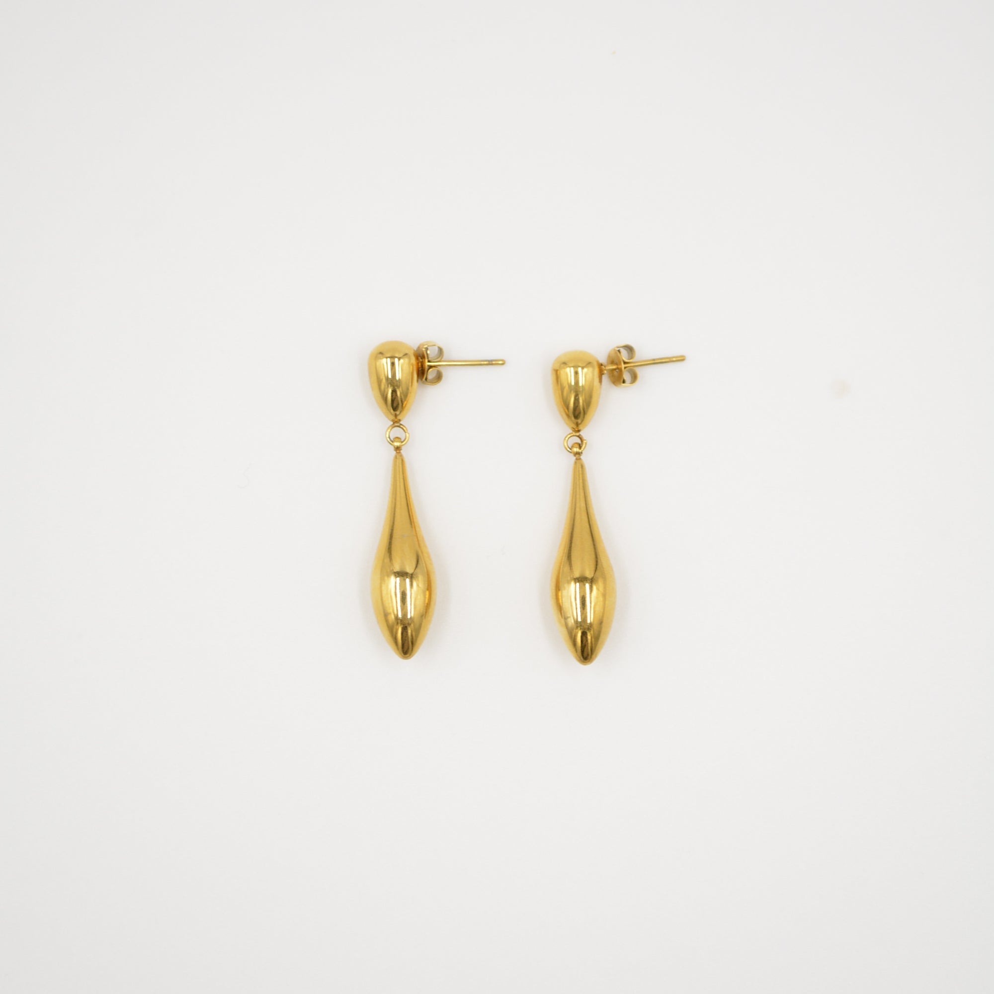 Pair of gold earrings on a light gray background